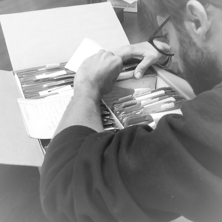 Alessandro Cariboni handling historical documents during archival research